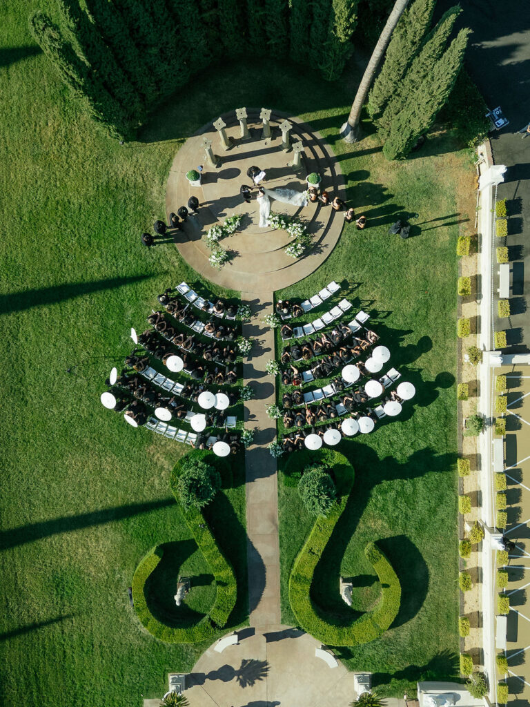 Aerial view of outdoor ceremony at Grand Island Mansion with bride and groom at the altar.