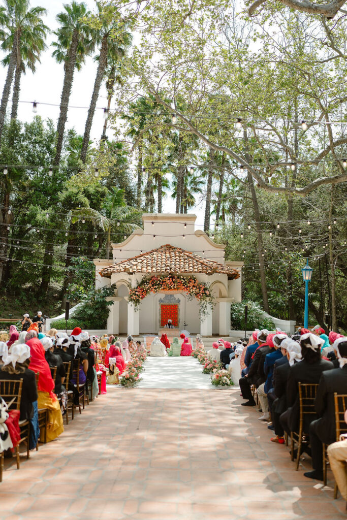 View of Rancho Las Lomas wedding ceremony with guests seated and altar in background.

