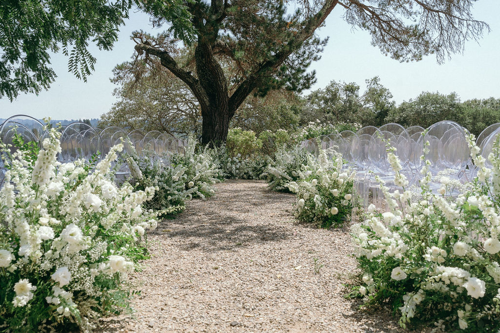 Beautiful ceremony setup with acrylic chairs and white florals at Dalya Estate Wedding