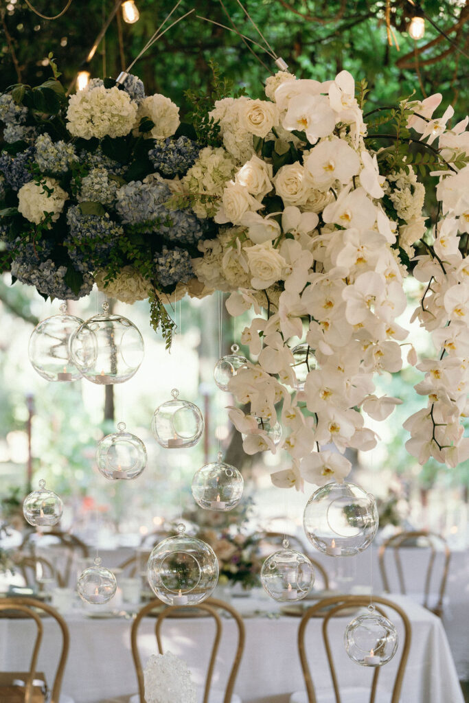  Close-up of a stunning white and blue floral chandelier centerpiece at a Mendocino wedding reception.