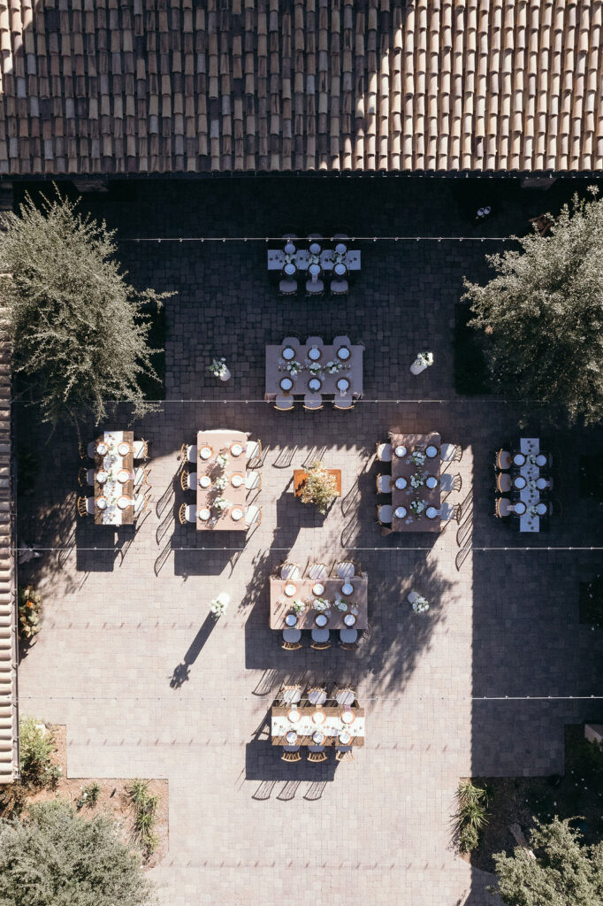 Aerial view of courtyard reception at Monserate Winery showcasing Tuscan-inspired table arrangements and decor.