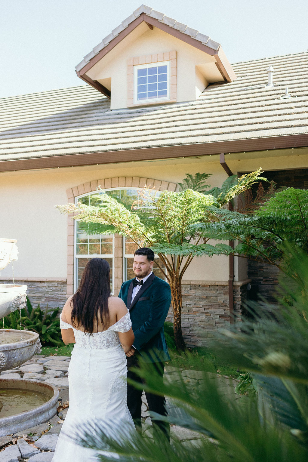 Bride and groom holding hands during a first look moment in the Wolfe Heights courtyard.