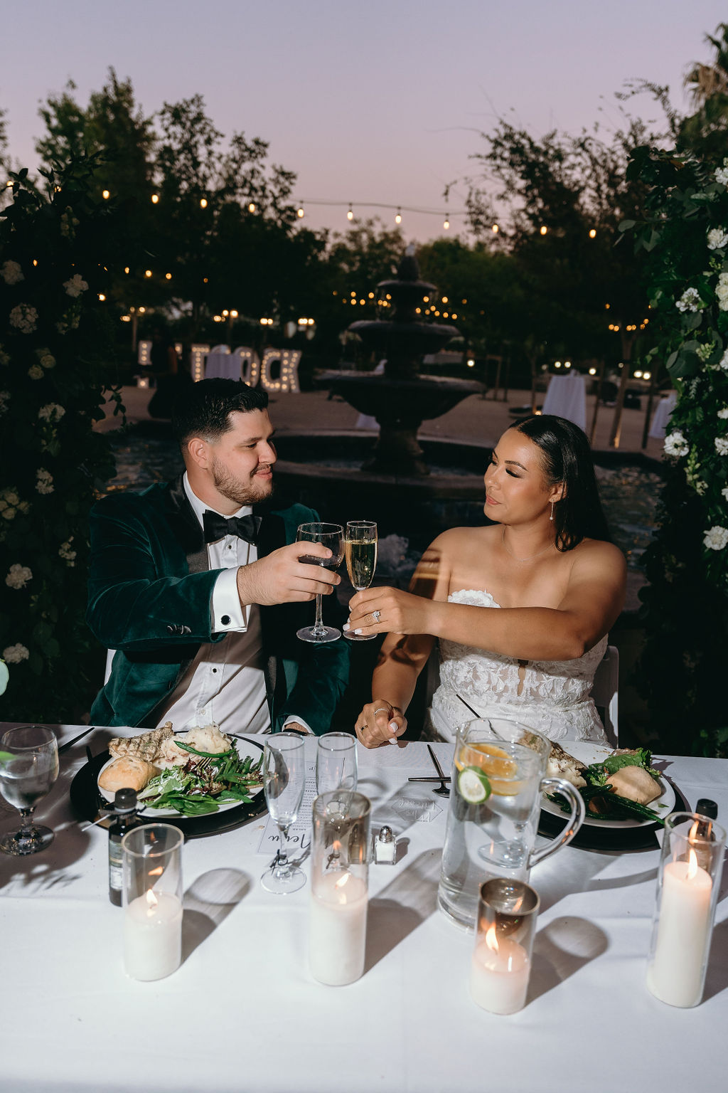 Bride and groom share a toast at their candlelit sweetheart table during Wolfe Heights Wedding reception