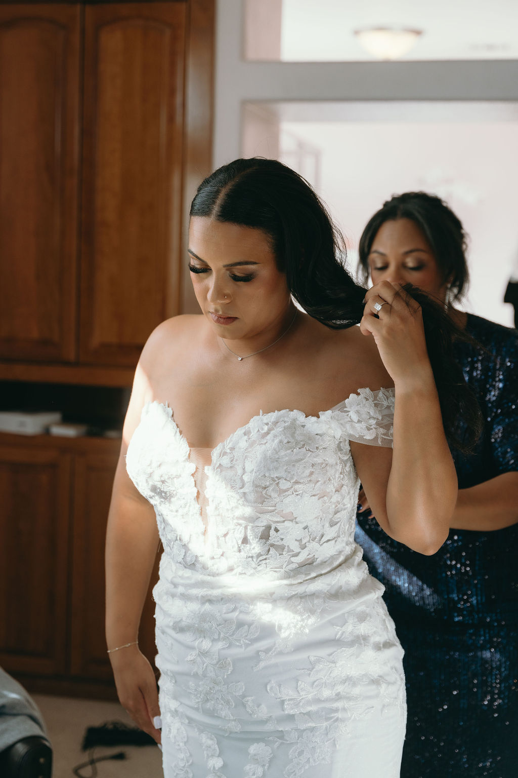 Bride getting ready in a lace wedding gown, focusing on her hairstyle at Wolfe Heights Wedding