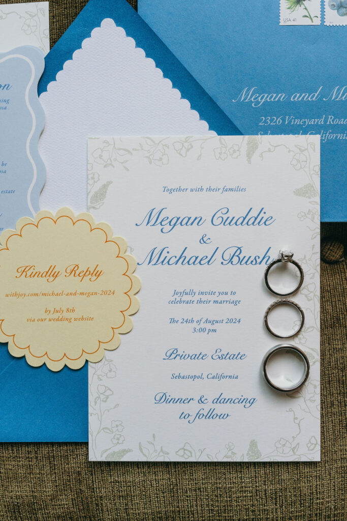 Elegant wedding invitation suite with rings displayed on top in Sebastopol, California