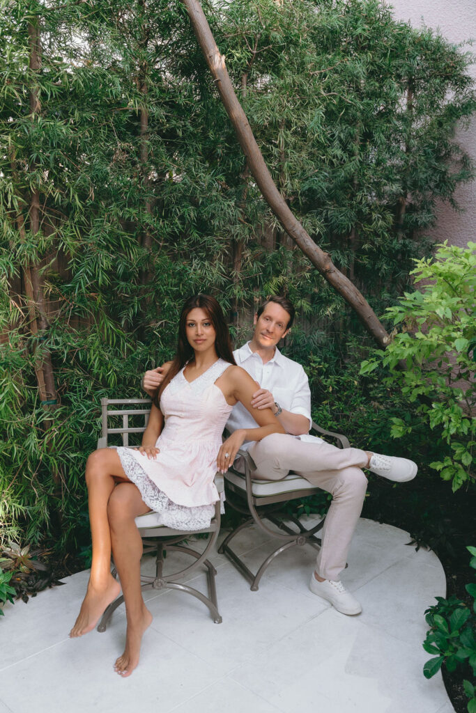 Couple poses in a lush green garden after their intimate Los Angeles proposal