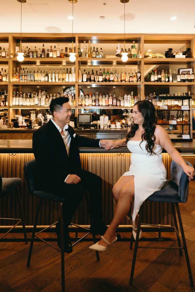 Romantic bar engagement session at a luxury hotel in San Diego, featuring warm lighting and chic deco