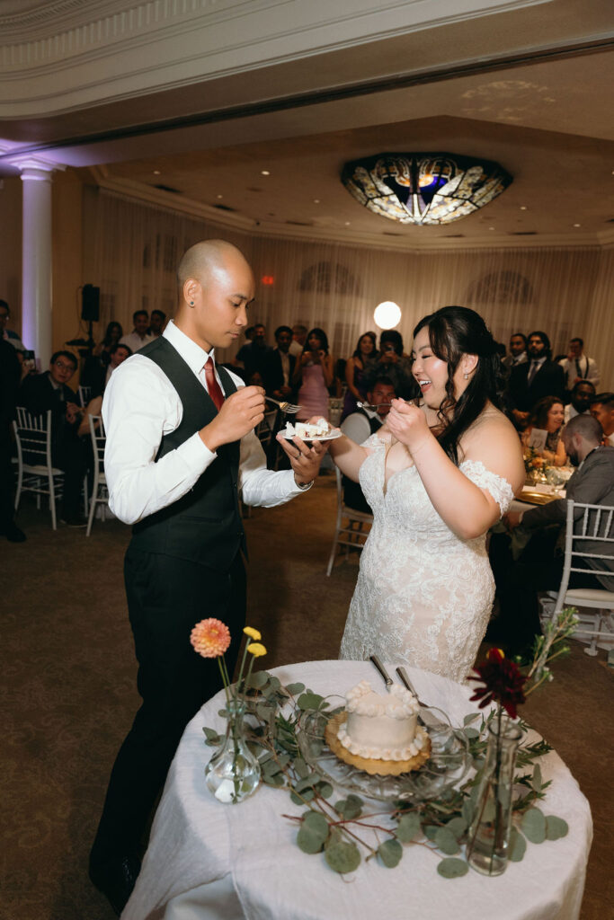 Close-up of the bride with a piece of cake, enjoying a sweet moment