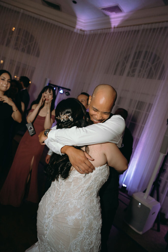 Bride and groom share their first dance with guests cheering at Vizcaya Sacramento