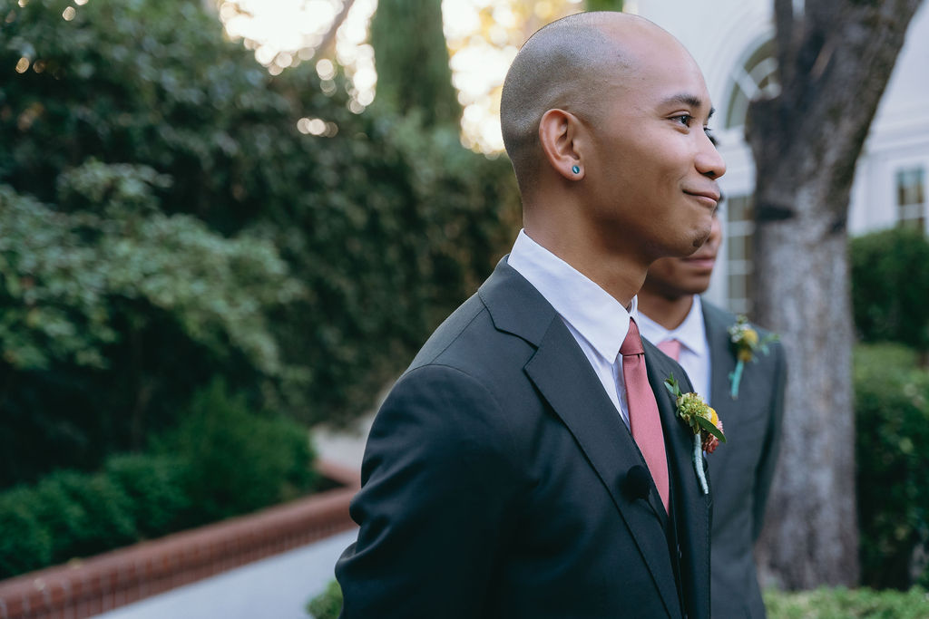 Groom waits at the altar with a soft smile as the bride approaches at Vizcaya Sacramento