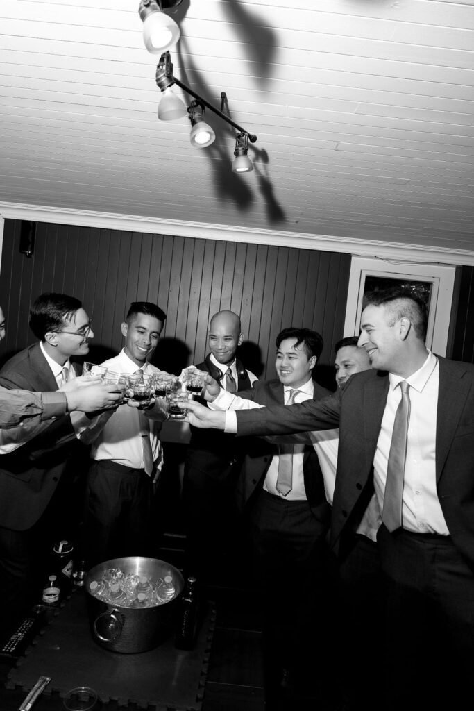 Groom and groomsmen toasting in the basement suite at Vizcaya Sacramento before the wedding ceremony