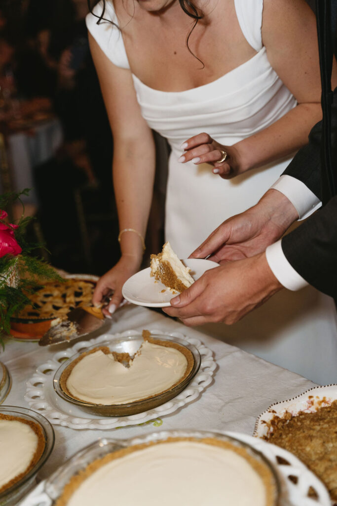 Bride and groom cutting into their wedding pie during reception captured by a Northern California Wedding Photographer