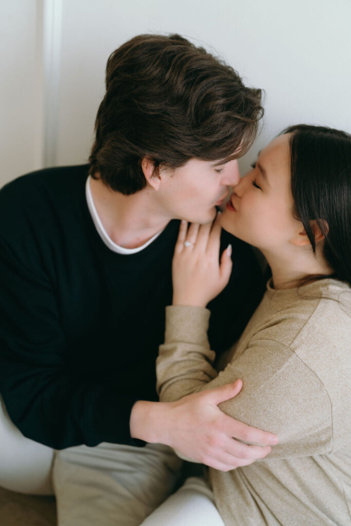 Close-up of couple sharing a quiet moment, embracing softly during their DTLA studio engagement session.