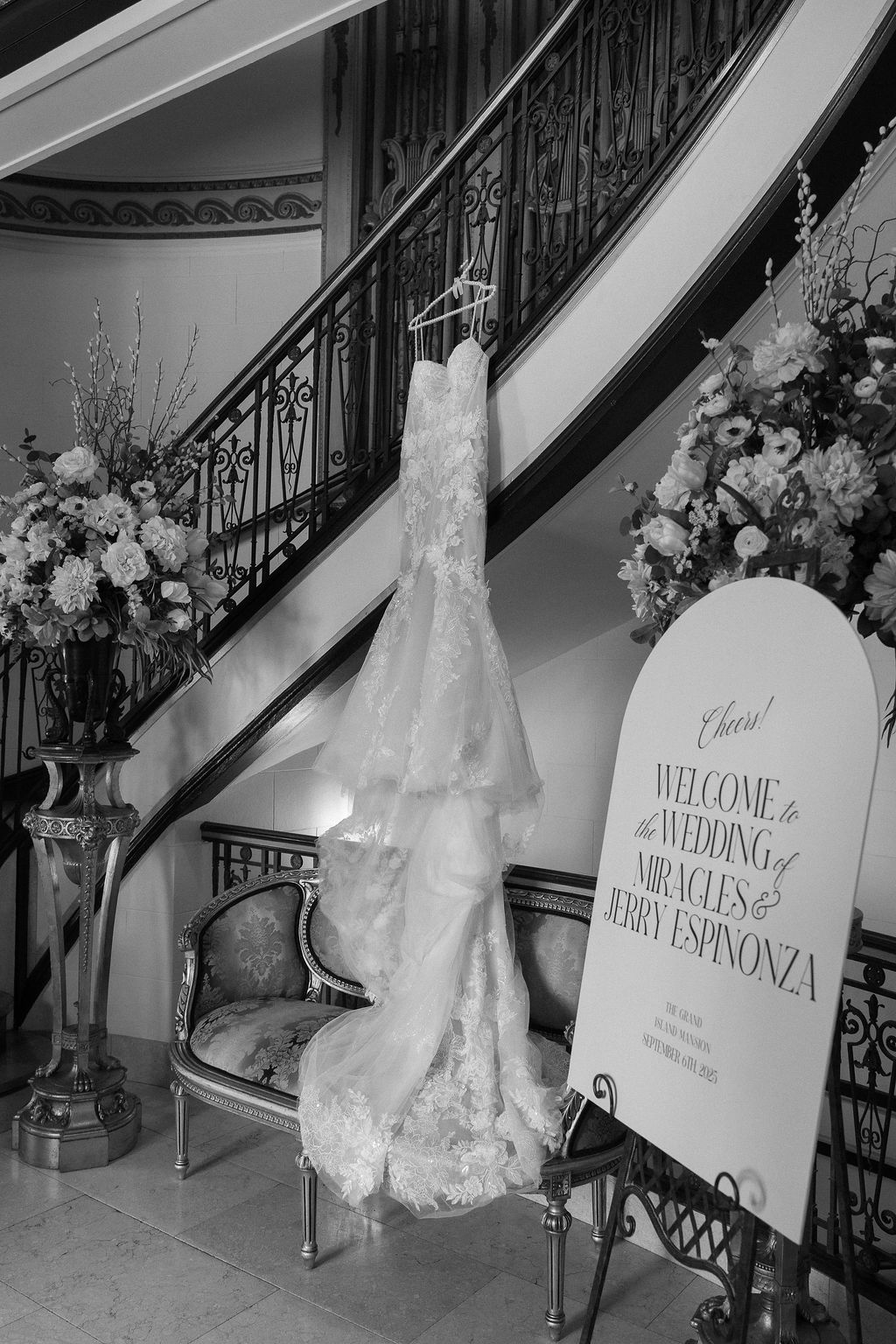 Wedding gown hanging on ornate staircase inside Grand Island Mansion.