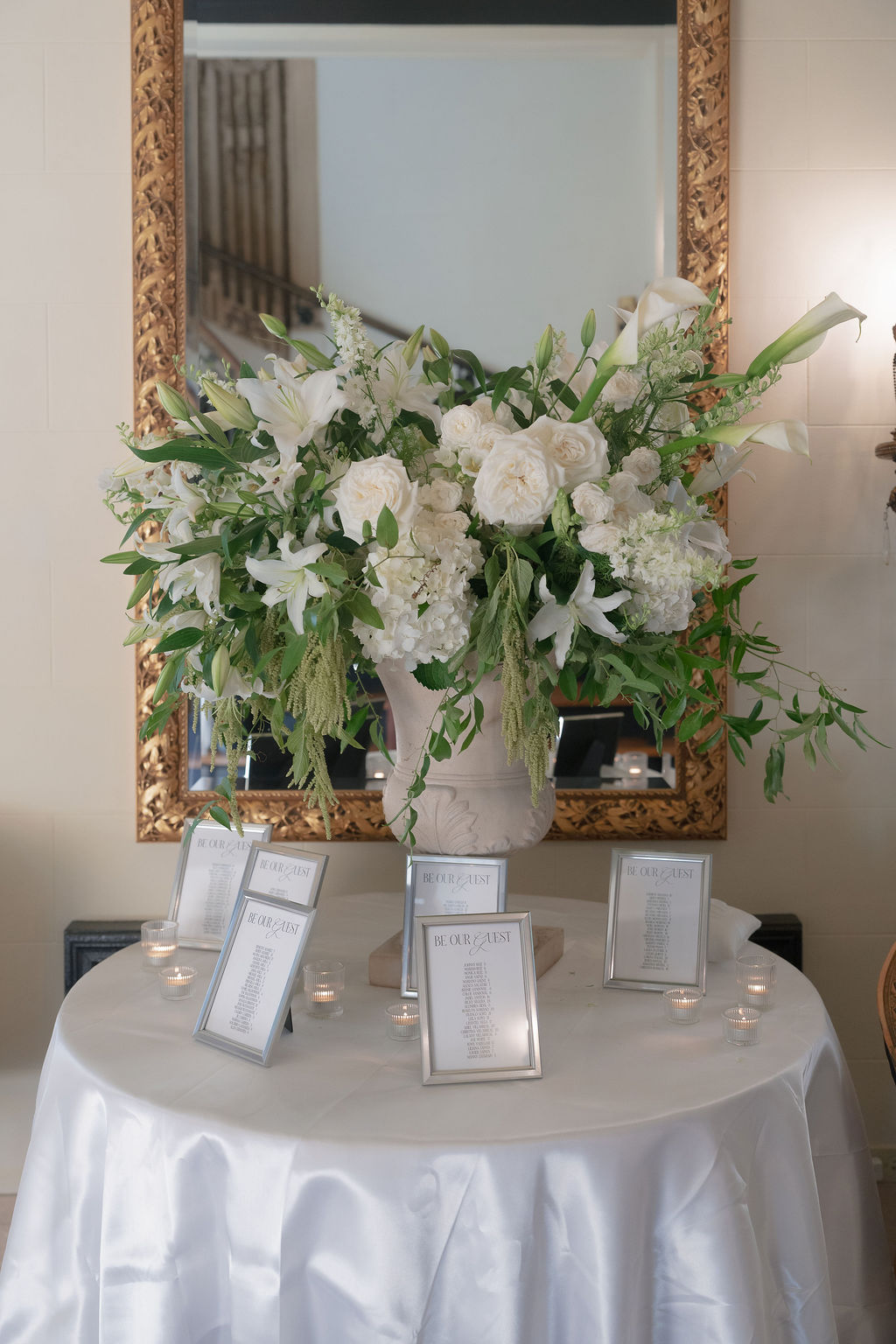 Large floral arrangement with seating charts inside Grand Island Mansion.