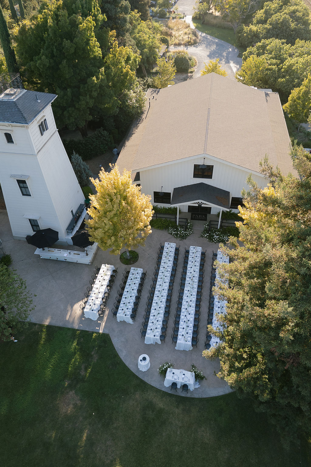 Aerial view of outdoor reception tables beside the barn at Park Winters wedding.