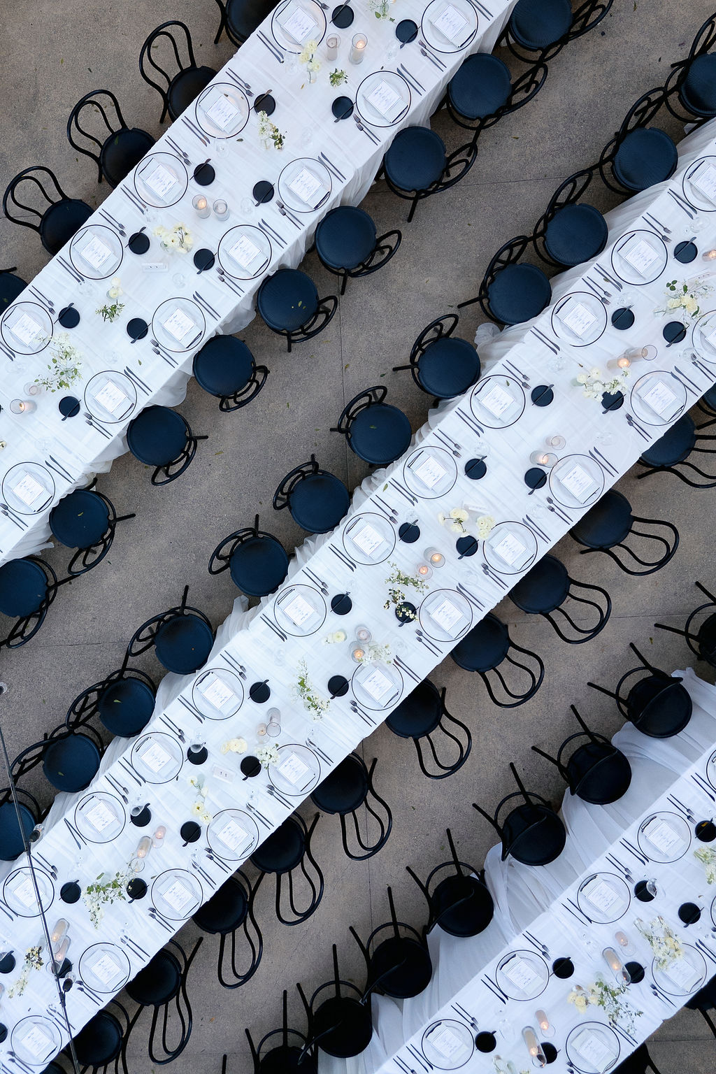 Overhead shot of elegant Park Winters wedding reception tables with black chairs and white linens