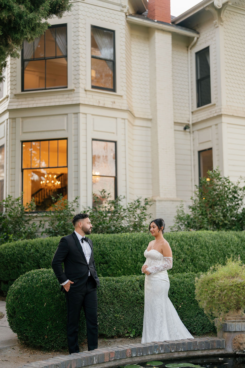 Bride and groom sharing a quiet moment by the historic mansion at Park Winters Wedding.