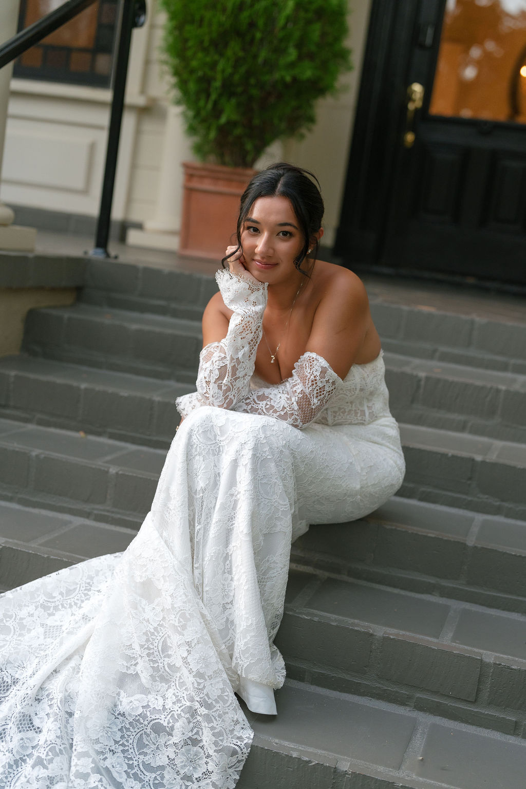 Bride sitting on steps in lace gown at Park Winters wedding portrait session.
