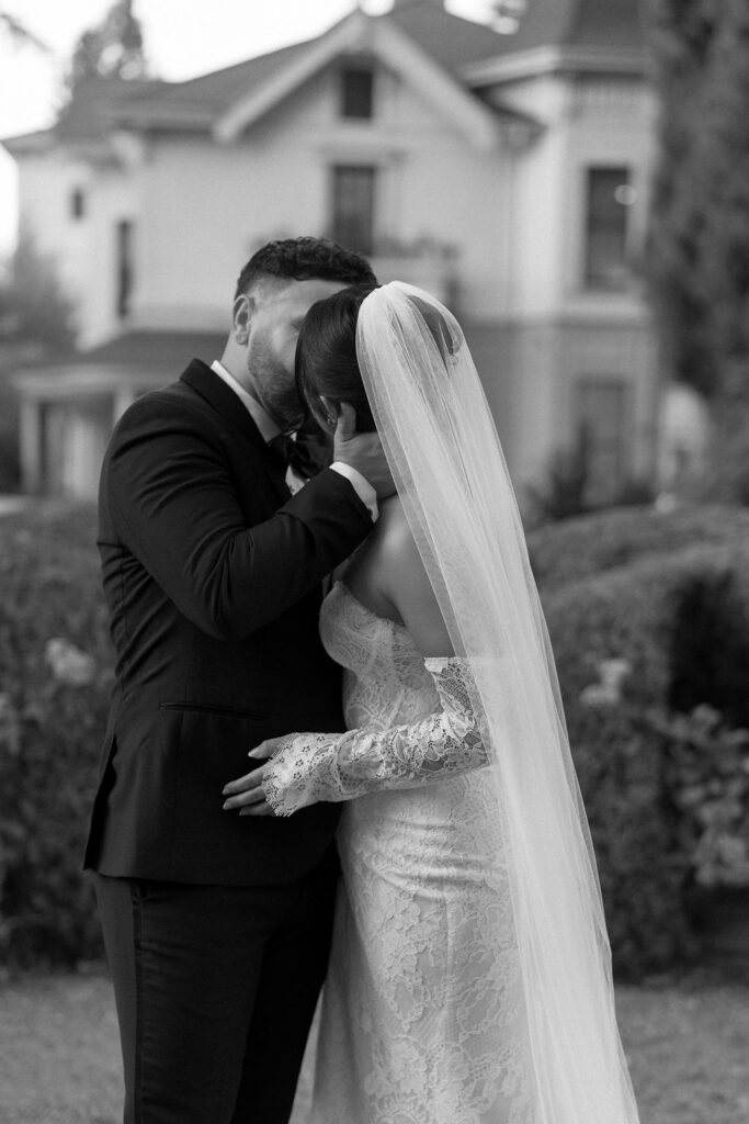 Black and white photo of bride and groom kissing during their Park Winters wedding.