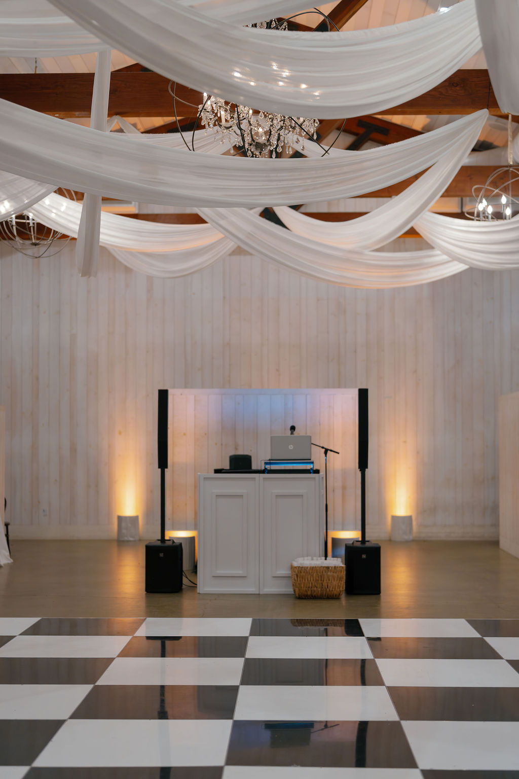 Black and white dance floor and barn ballroom lined with white drapery on the ceiling at Park Winters