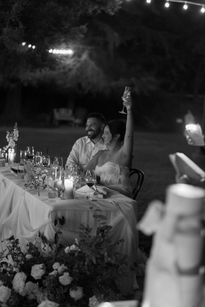 Bride raises champagne glass during toasts at Park Winters wedding reception.