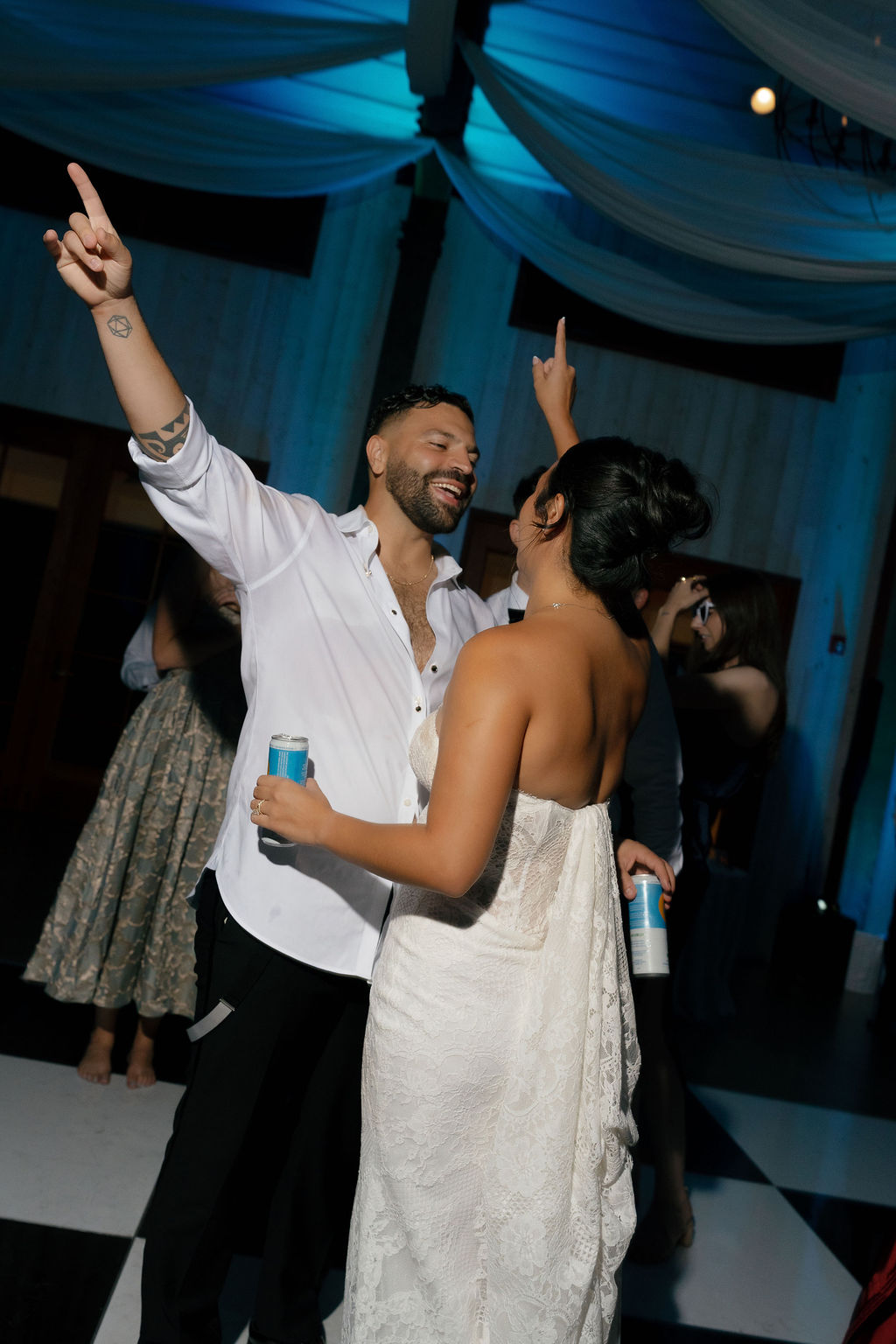 Couple enjoys energetic dance with drinks in hand during Park Winters Wedding reception